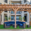 a covered sitting area with a blue sofa