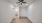 spacious bedroom with ceiling fan and wood flooring