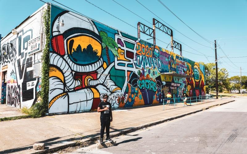 Find your perfect fit at Canal Street Flats a person standing in front of a wall with graffiti