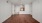 a room with white walls and a ceiling fan