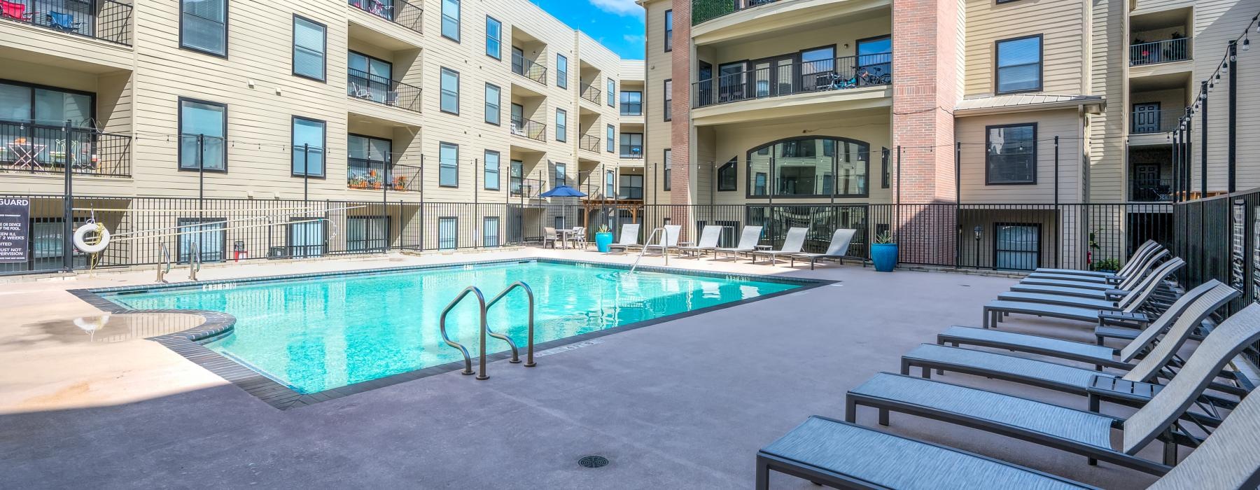 a swimming pool in a courtyard between buildings