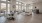 a large gathering room with a wood floor and a large window